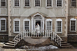 Fashion portrait of beautiful woman on the front of old vintage building