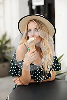 Fashion portrait of a beautiful woman outdoor with ice cream