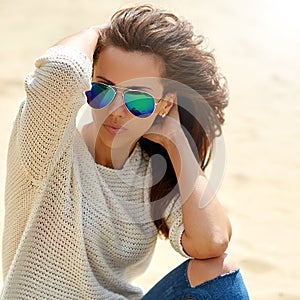 Fashion portrait of a beautiful woman in sunglasses - close up