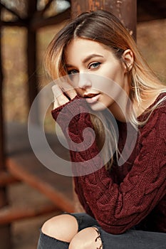 Fashion portrait of a beautiful young blonde girl in a stylish