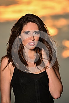 Fashion portrait of beautiful young woman posing on the beach.