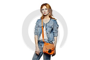 Fashion portrait of beautiful young woman with handbag