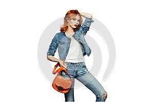 Fashion portrait of beautiful young woman with handbag