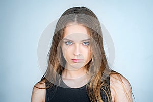 Fashion portrait of a beautiful young woman posing over white background. Close up portrait of a beautiful young woman