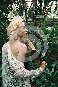 Fashion portrait of beautiful young woman in tropical forest