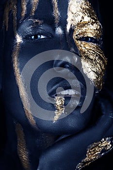 fashion portrait of a blue-skinned girl with gold make-up. Beauty face.