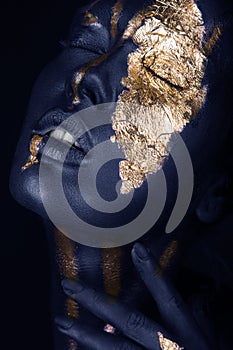 fashion portrait of a blue-skinned girl with gold make-up. Beauty face.