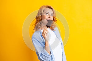 Fashion portrait cool young woman with ice cream over yellow background. Young cheeky hipster girl eating an ice cream