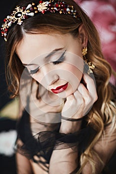 Fashion portrait of elegant luxurious woman with perfect makeup and expensive trendy gold jewelry. Model girl with wavy