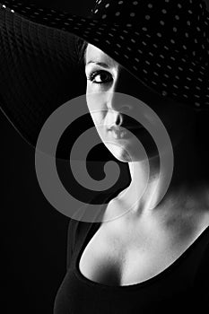 Fashion portrait of elegant woman in black and white hat