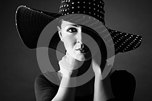 Fashion portrait of elegant woman in black and white hat