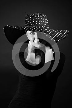 Fashion portrait of elegant woman in black and white hat