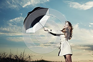 Fashion portrait of elegant woman in a raincoat