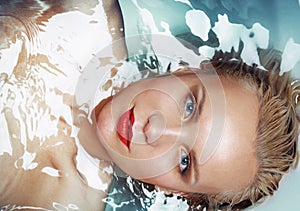 Fashion portrait of fascinating glamourous woman in water