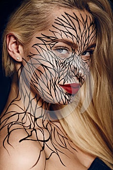 Fashion portrait of girl with faceart photo