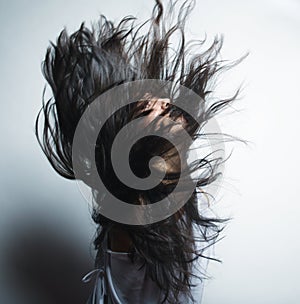 Fashion portrait of a girl with hair lightly fluttering in the w
