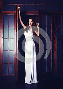 Fashion portrait of a girl wearing a long white dress