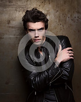 Fashion portrait of handsome young man in a black leather jacket