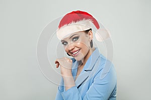 Fashion portrait of happy Christmas woman in Santa hat on white background