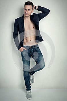 Fashion portrait of a hot male model in stylish jeans