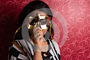 Fashion portrait of an Indian Bengali beautiful and young girl in western dress wearing an eye mask