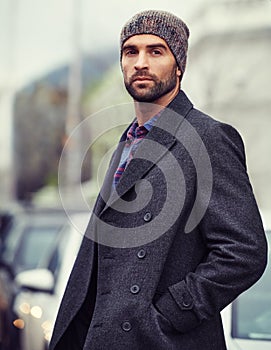 Fashion, portrait or man in city with coat for edgy clothes, outdoor travel or elegant style for winter outfit. Town