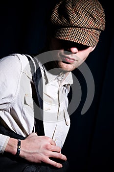 Fashion portrait of man in peaked cap