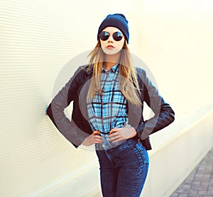 Fashion portrait pretty blonde woman posing in rock black style