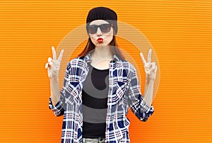 Fashion portrait pretty cool girl wearing a black hat, sunglasses and shirt