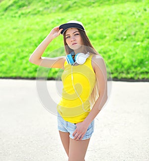 Fashion portrait of pretty cool girl wearing a cap