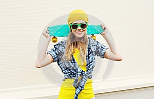 Fashion portrait pretty cool smiling girl with skateboard over white