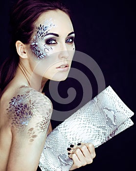 fashion portrait of pretty young woman with creative make up lik