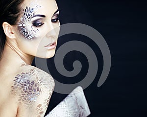 fashion portrait of pretty young woman with creative make up lik