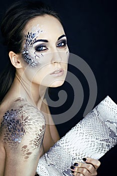 fashion portrait of pretty young woman with creative make up lik