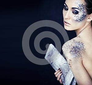 Fashion portrait of pretty young woman with creative snake make
