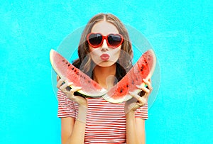 Fashion portrait pretty young woman is holding slice of watermelon and blowing lips