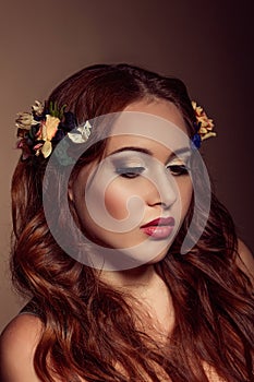 Fashion portrait of red-haired woman. Floral elements.