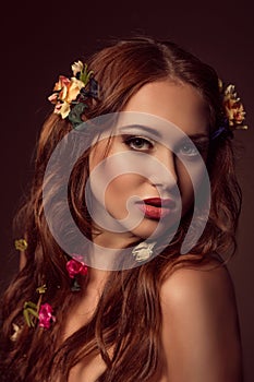 Fashion portrait of red-haired woman. Floral elements.