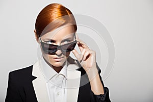 Fashion portrait of serious woman dressed as a secret agent
