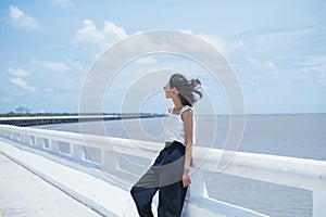 Fashion portrait - Slimmy asian woman on the sea road