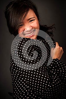 Fashion portrait in studio of beautiful young asian smiling woman feeling happy in success life