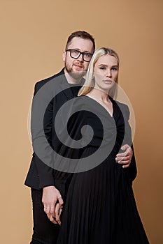 Fashion portrait of a stylish couple in love in black clothes. A man and a woman embrace