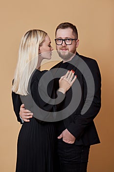 Fashion portrait of a stylish couple in love in black clothes. A man and a woman embrace