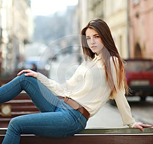 Fashion portrait stylish urban girl posing old city street