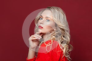 Fashion portrait of stylish woman with perfect makeup. Beautiful model woman with curly hairstyle. Care and beauty, lady in red