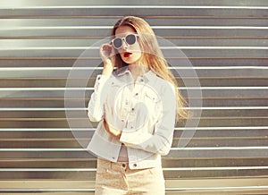 Fashion portrait stylish woman in sunglasses and white denim