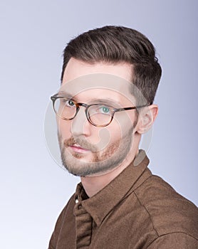 Fashion portrait of stylish young man in brown shirt. The beard