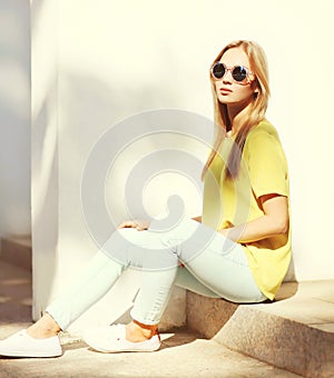 Fashion portrait of trendy pretty blonde woman in city