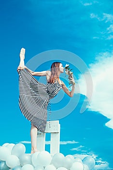 Fashion portrait of woman. girl with flowers sit in sky. feeling freedom and dreaming. inspiration and imagination