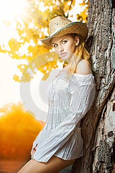 Fashion portrait woman with hat and white shirt in the autumn day